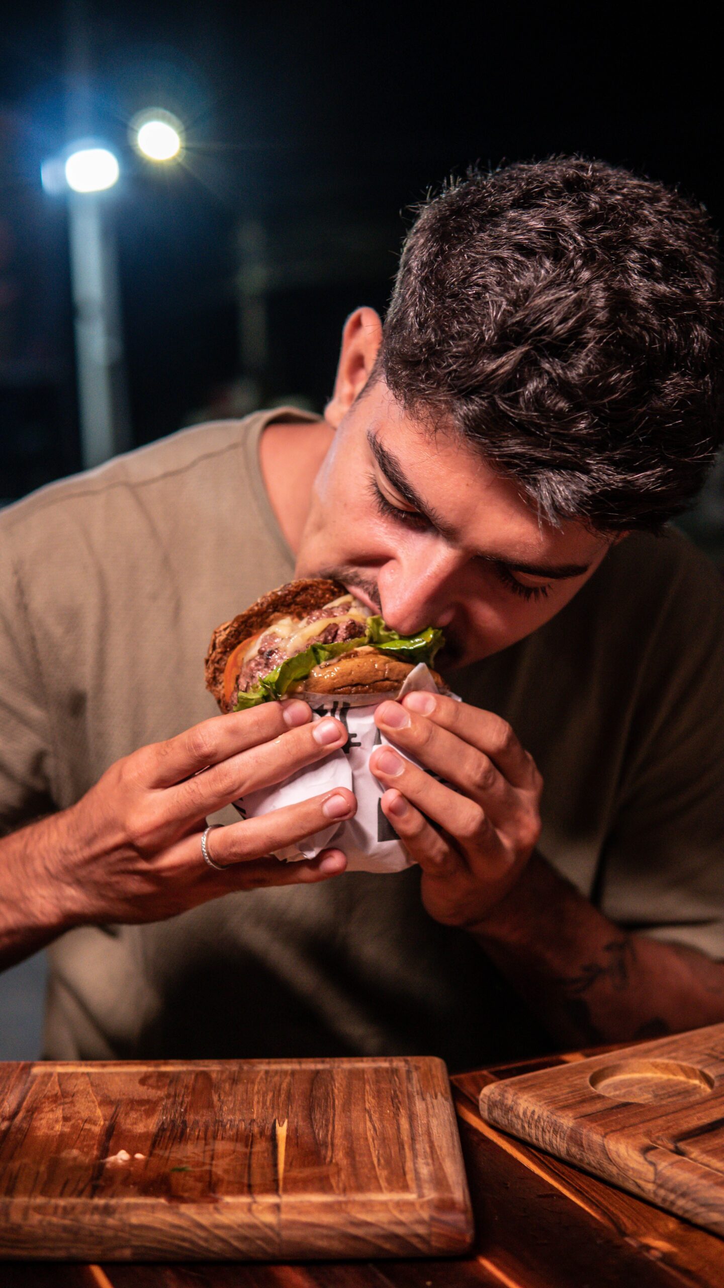 The Food World Keeps Upgrading the Menu While Leaving the Eater Untouched. man eating burger. Knowing what to eat doesn't always help.